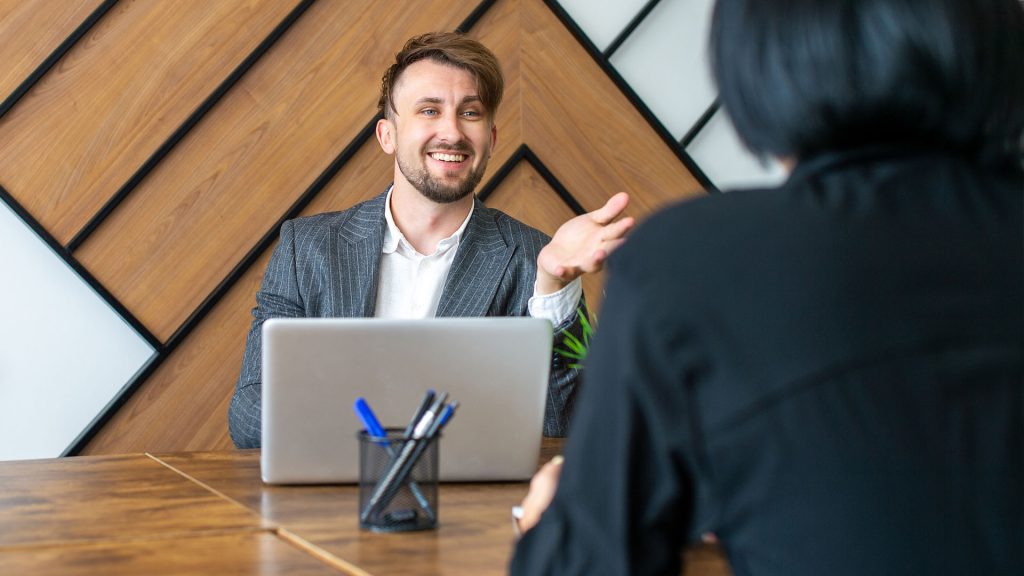 A man converses with his interviewer at a job interview.